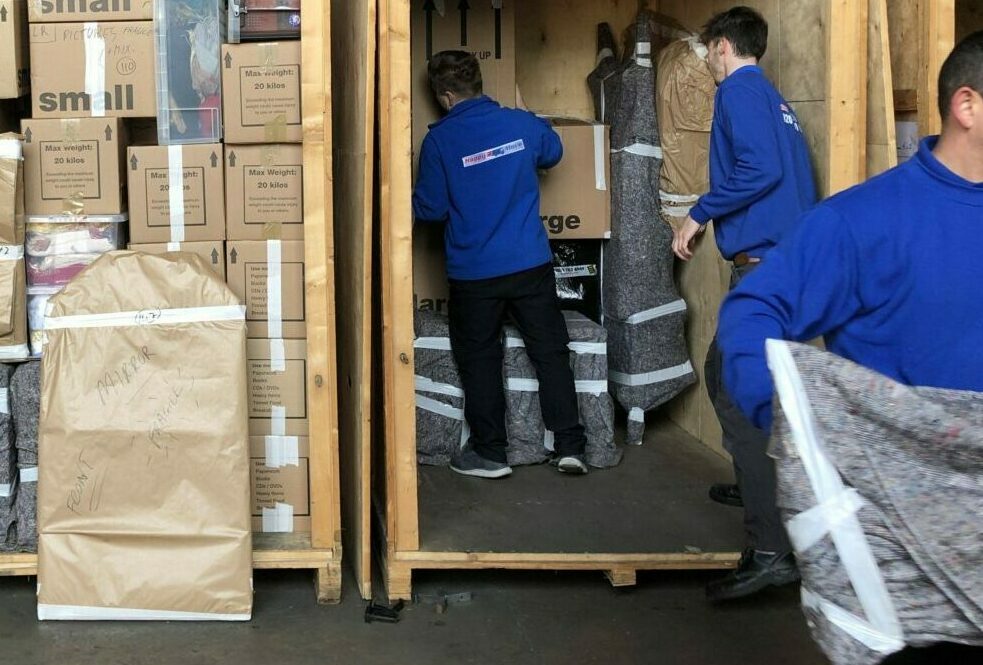 Happy2move team loading containers in our storage facility